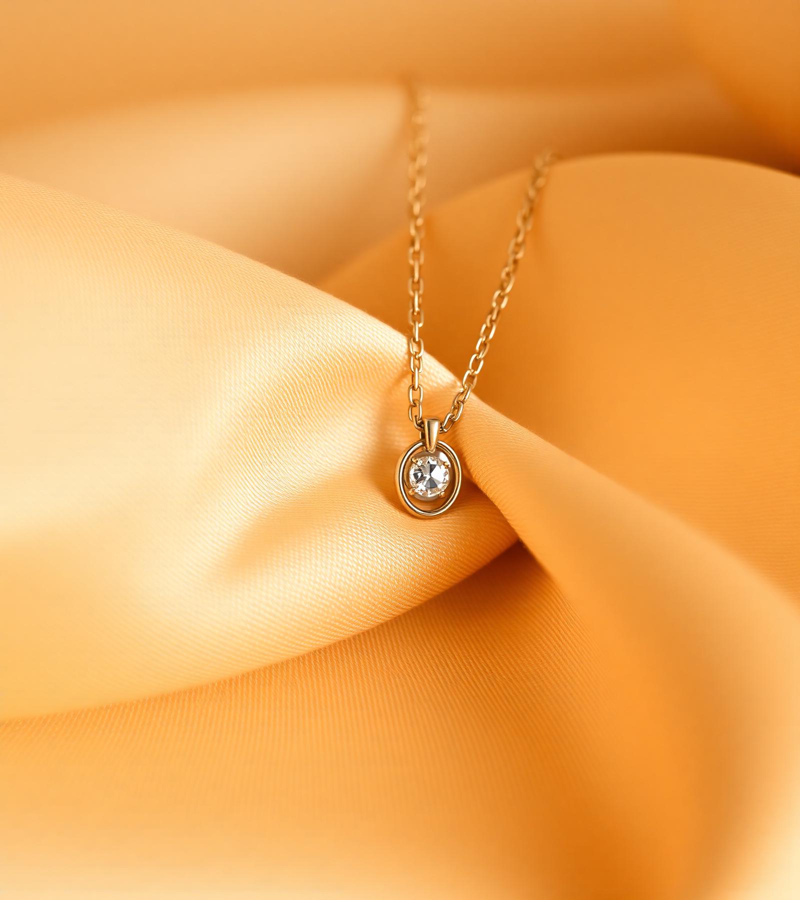 Gold-plated pendant necklace on warm silk
